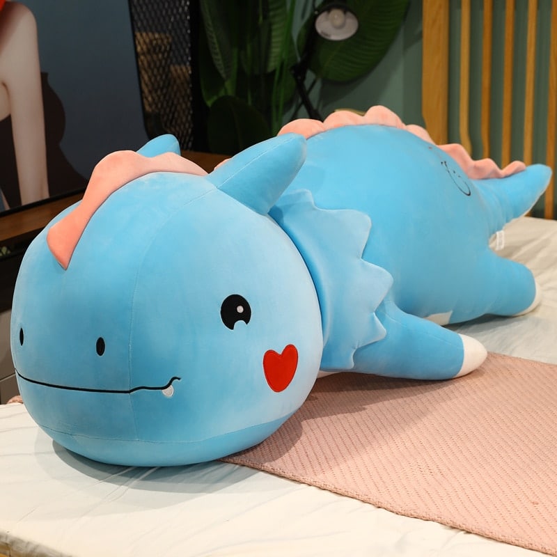 Peluche dinosaure mignon grand doux bleu allongé sur un lit